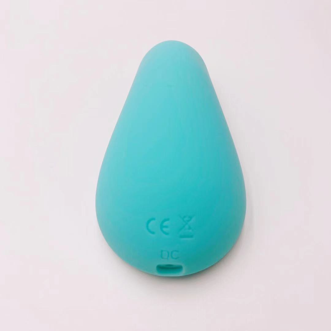 Teal silicone teether on a light gray background