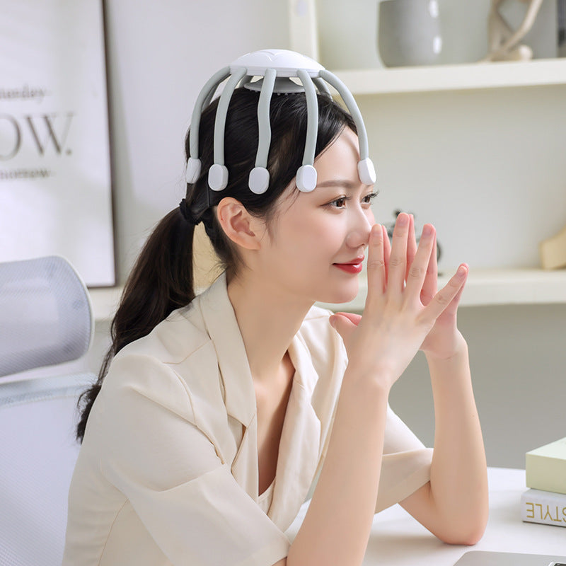 Woman wearing a white headband with small round devices, sitting indoors.